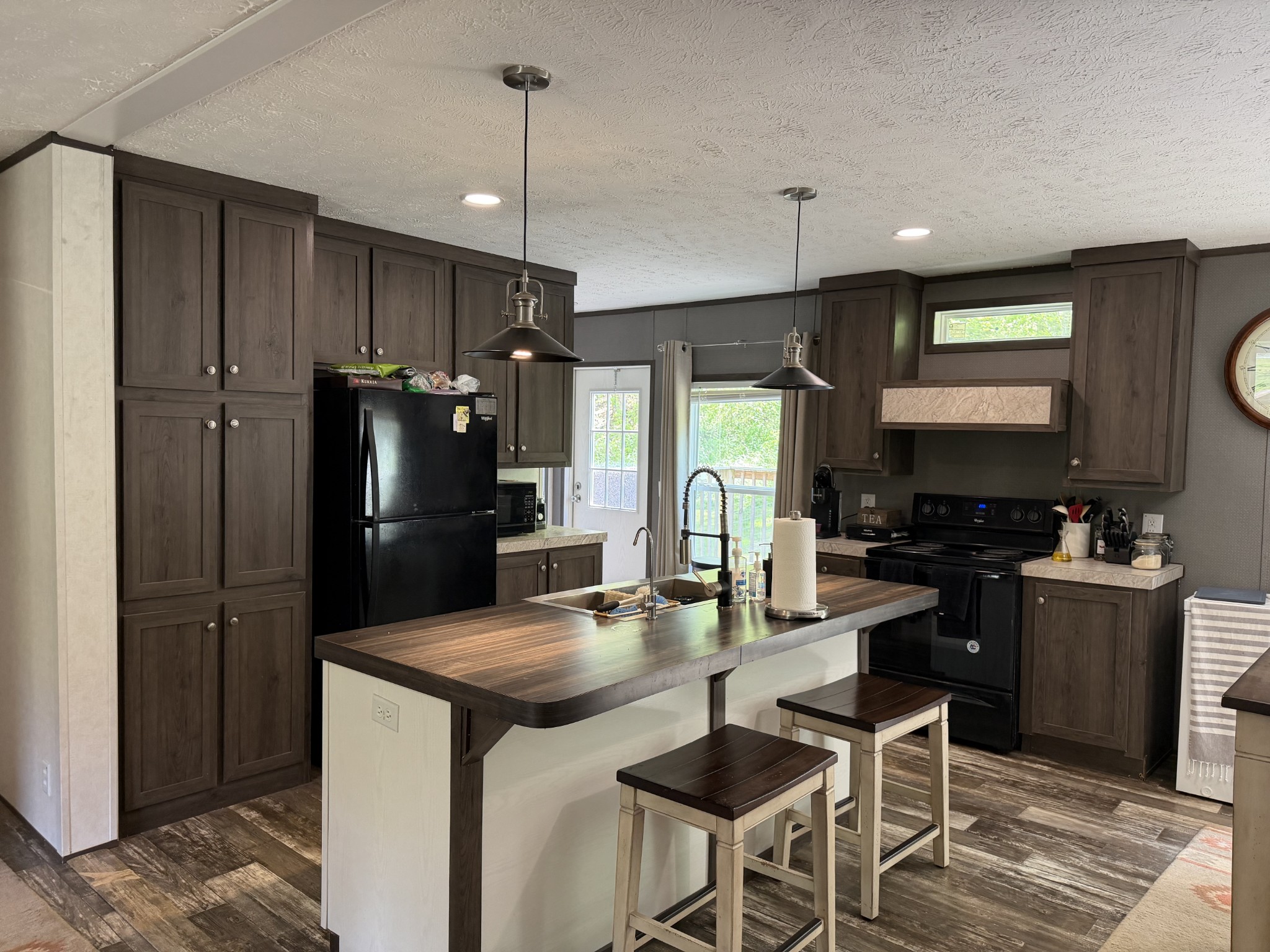 1851 Hicks Hollow Road Westmoreland, TN 37186 - Photo 3 of 12 a kitchen with stainless steel appliances granite countertop a refrigerator a stove a sink a dining table and chairs
