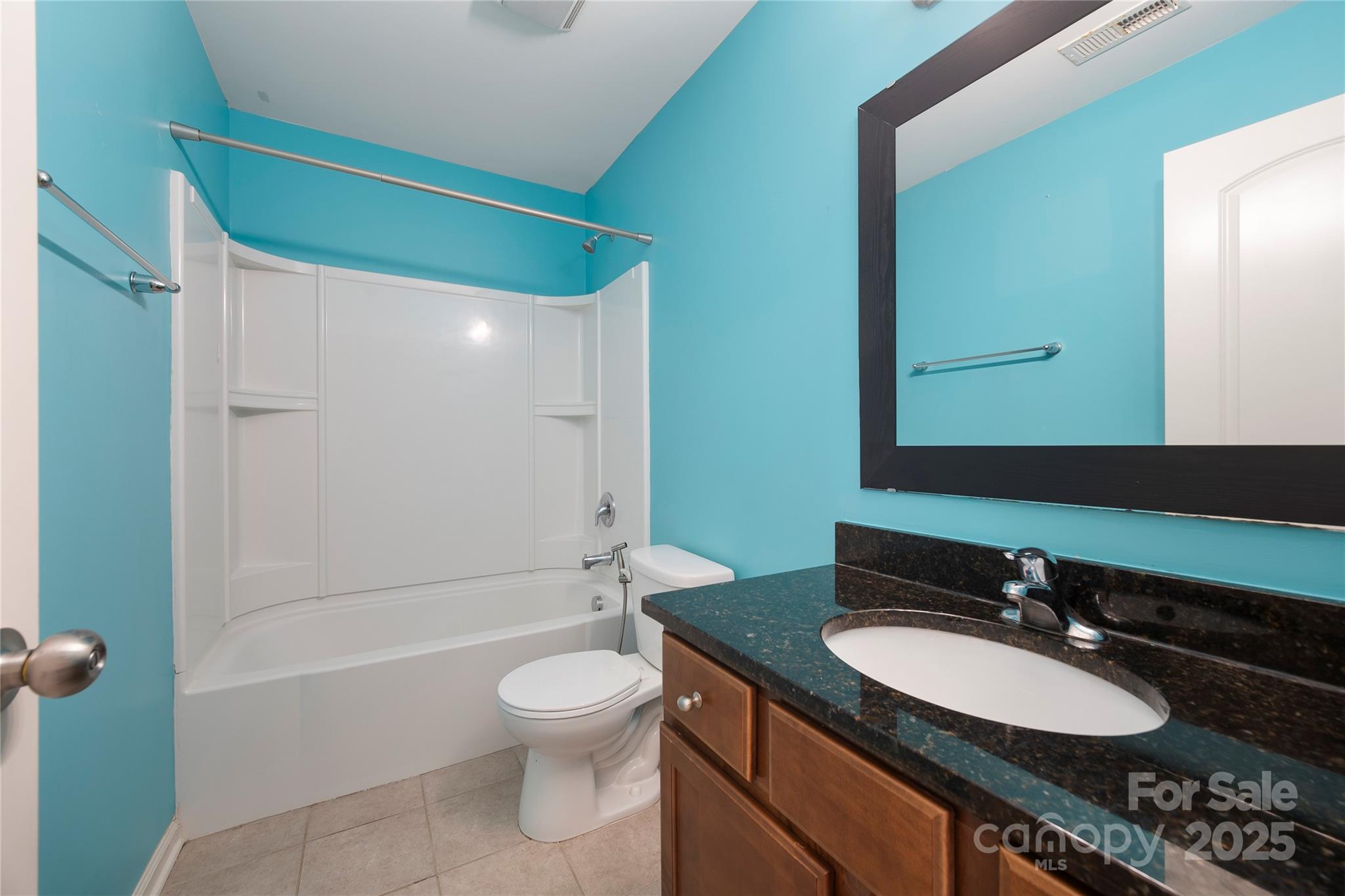 4720 Tradd Circle Monroe, NC 28110 - Photo 20 of 29 a bathroom with a granite countertop sink toilet a mirror and shower
