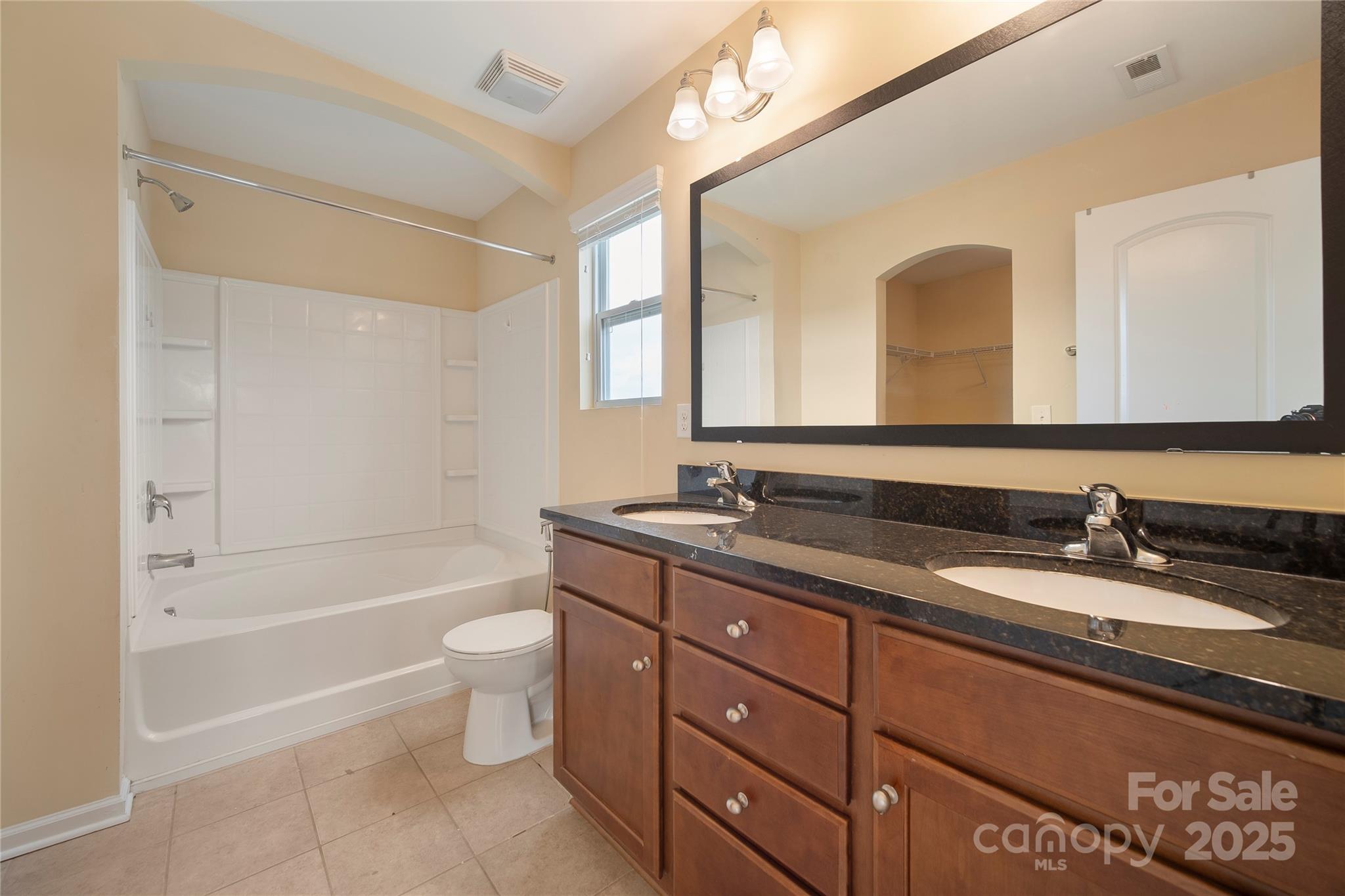 4720 Tradd Circle Monroe, NC 28110 - Photo 25 of 29 a bathroom with a granite countertop sink toilet mirror and bathtub