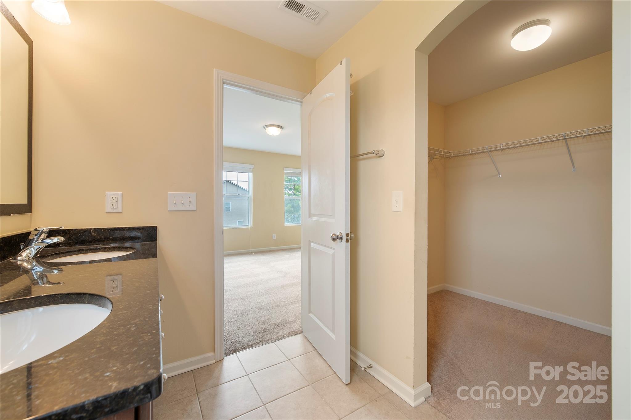 4720 Tradd Circle Monroe, NC 28110 - Photo 26 of 29 a bathroom with a granite countertop sink and a mirror