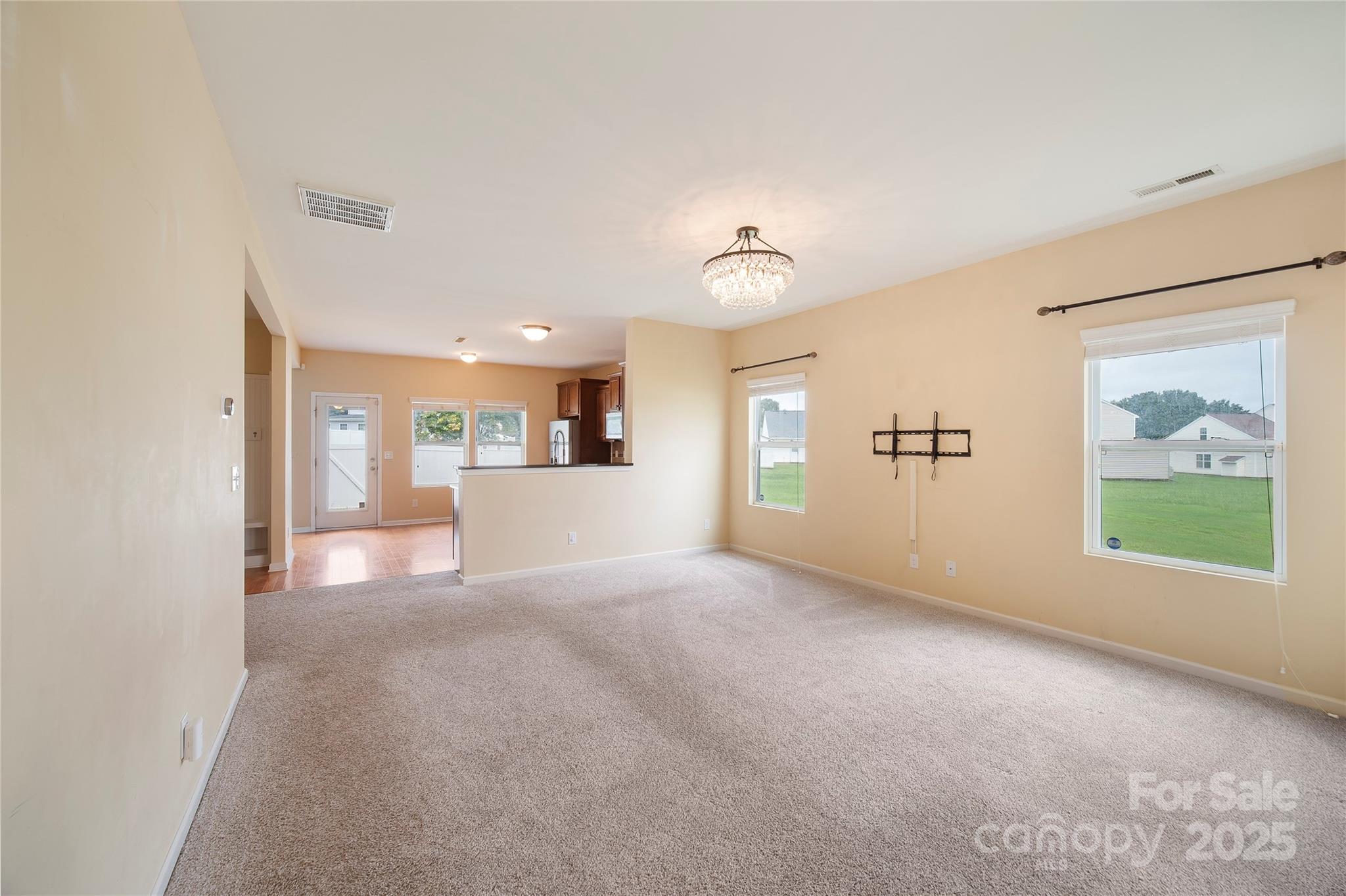 4720 Tradd Circle Monroe, NC 28110 - Photo 6 of 29 a view of a big room with windows and chandelier fan