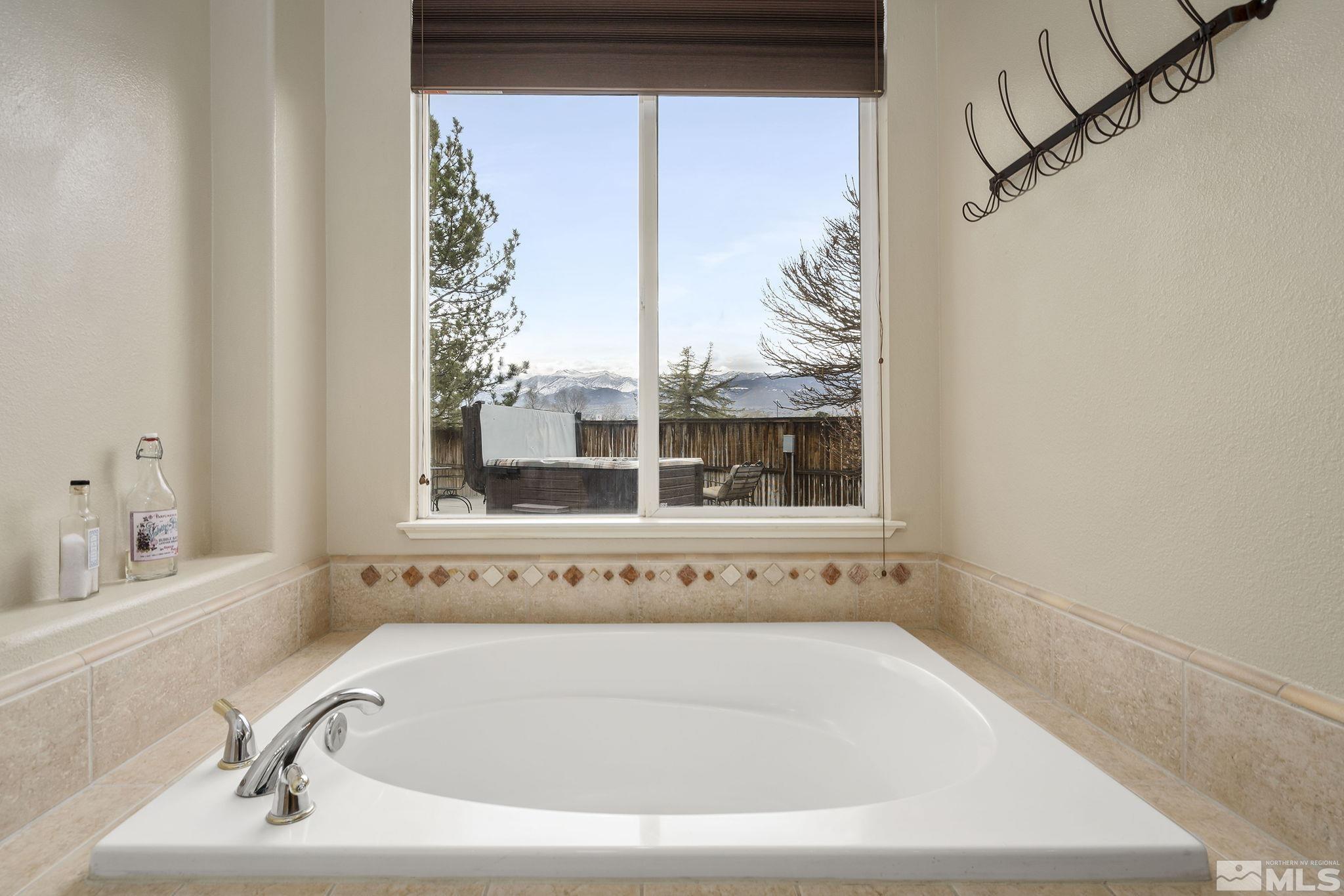 1564 Rio Grande Drive Reno, NV 89521 - Photo 16 of 33 a bathroom with a bathtub and a window