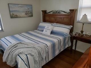 1767 Belvidere Road Englewood, FL 34223 - Photo 11 of 15 a bedroom with a bed and a lamp on table