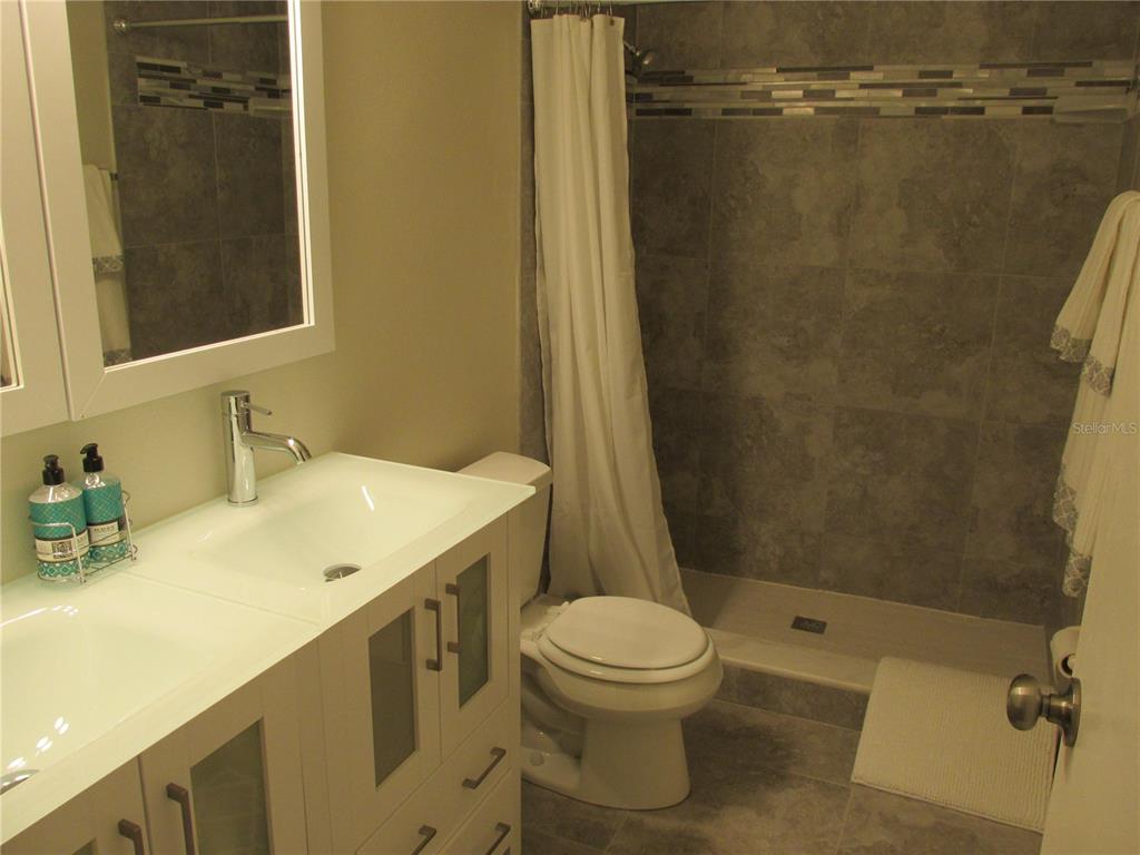 1767 Belvidere Road Englewood, FL 34223 - Photo 8 of 15 a bathroom with a sink a toilet and shower