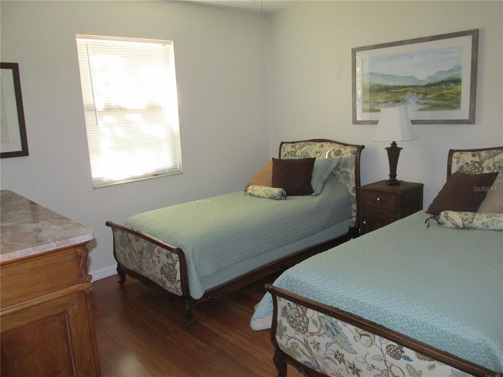 1767 Belvidere Road Englewood, FL 34223 - Photo 9 of 15 a bedroom with two beds and wooden floor