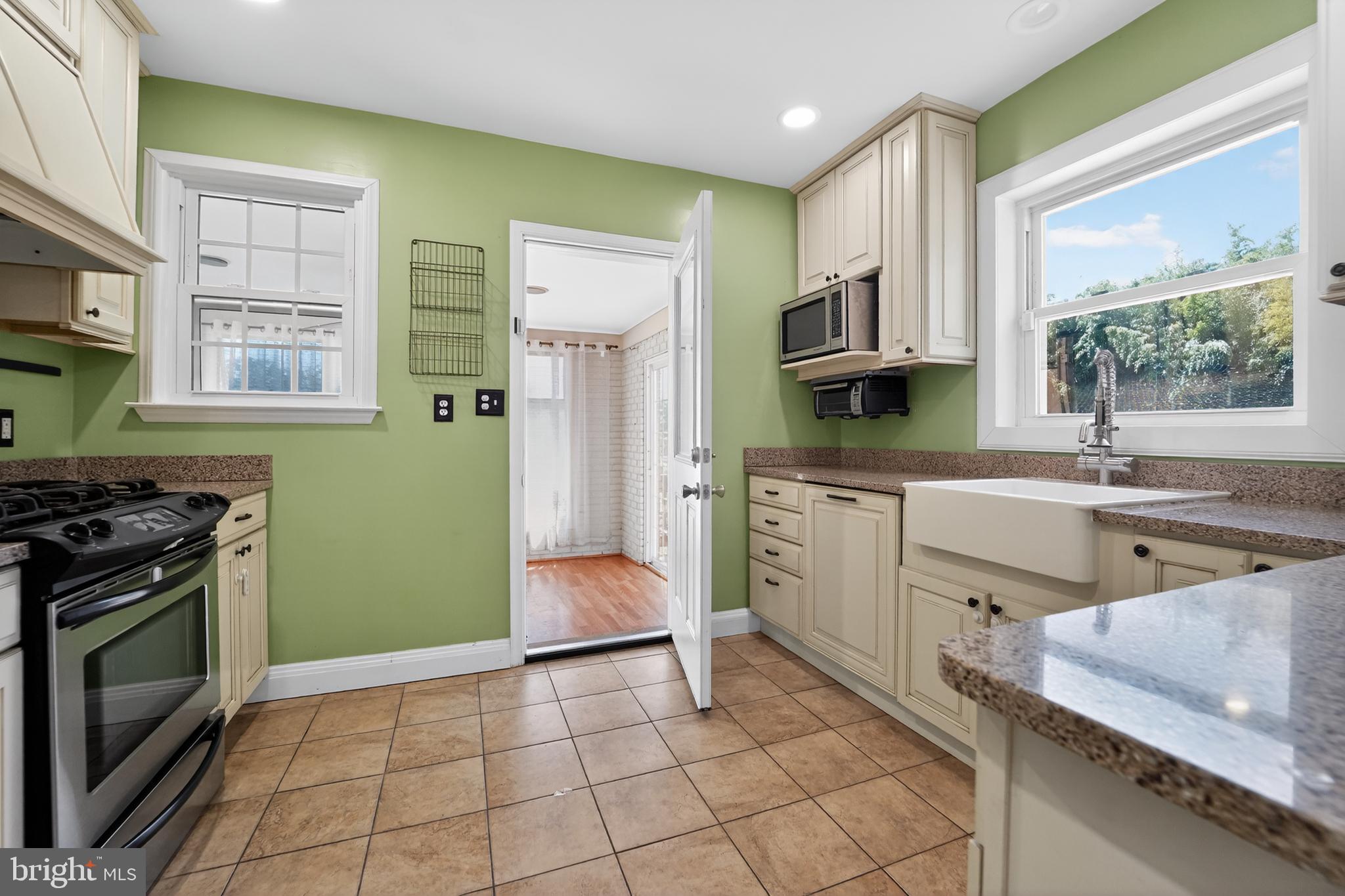 9408 Dana Vista Road Baltimore, MD 21236 - Photo 14 of 38 a kitchen with a stove sink and a microwave