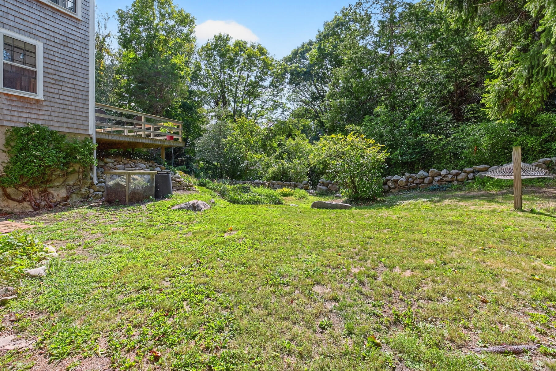 54 Whitman Road Woods Hole, MA 02543 - Photo 44 of 76 a view of a backyard with a garden