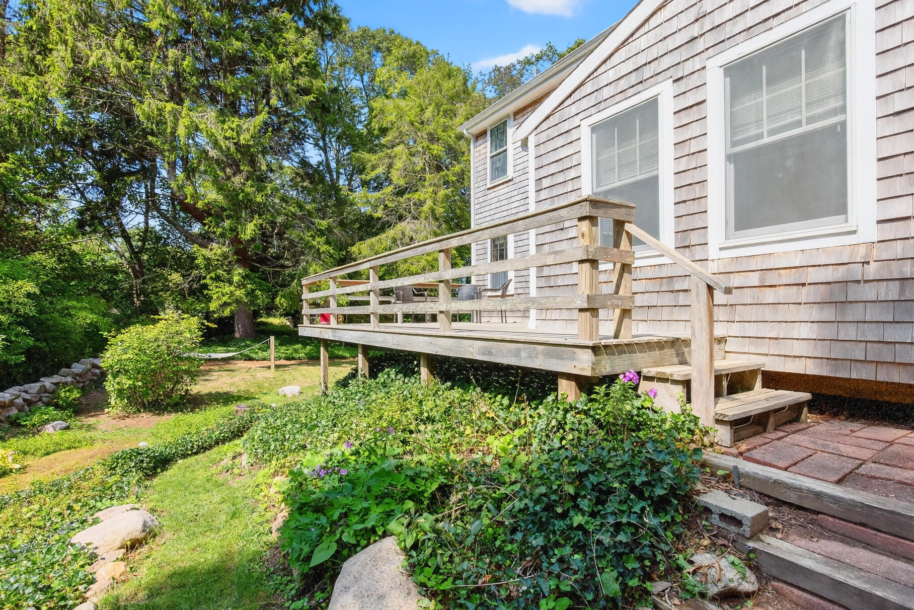 54 Whitman Road Woods Hole, MA 02543 - Photo 56 of 76 a view of a house with a yard and sitting area