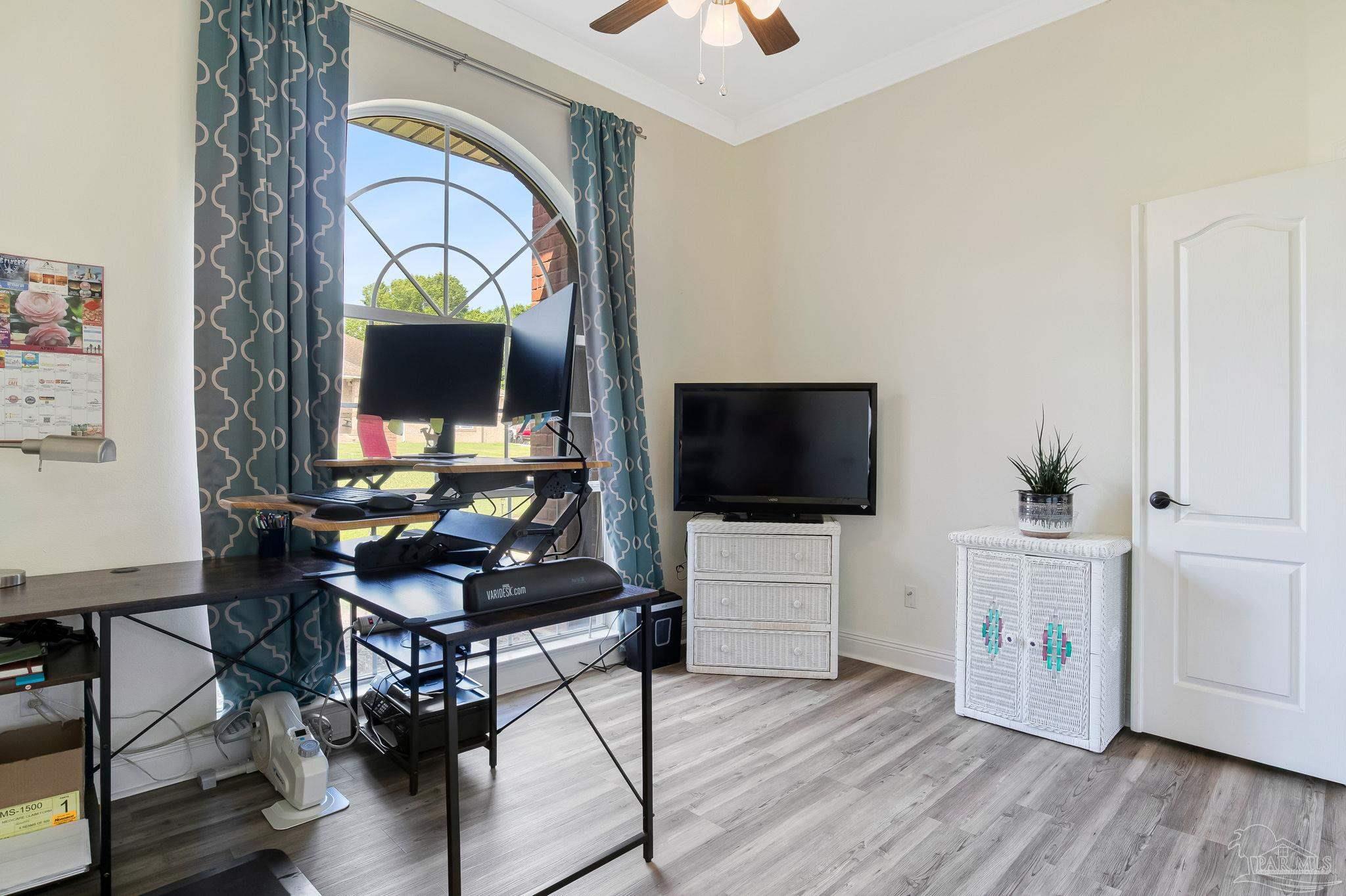 2822 Frederick Street Cantonment, FL 32533 - Photo 13 of 57 a living room with furniture and a flat screen tv
