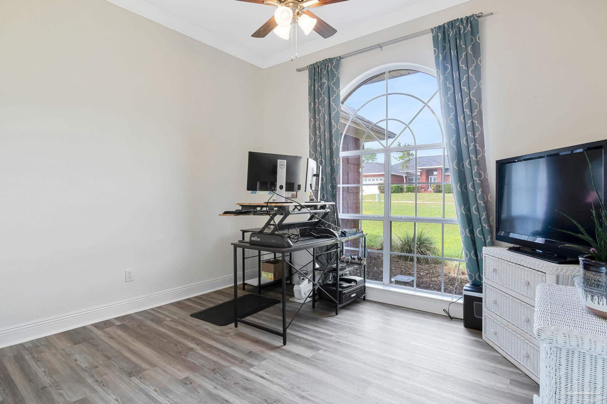 2822 Frederick Street Cantonment, FL 32533 - Photo 14 of 57 a view of a livingroom with furniture and a flat screen tv