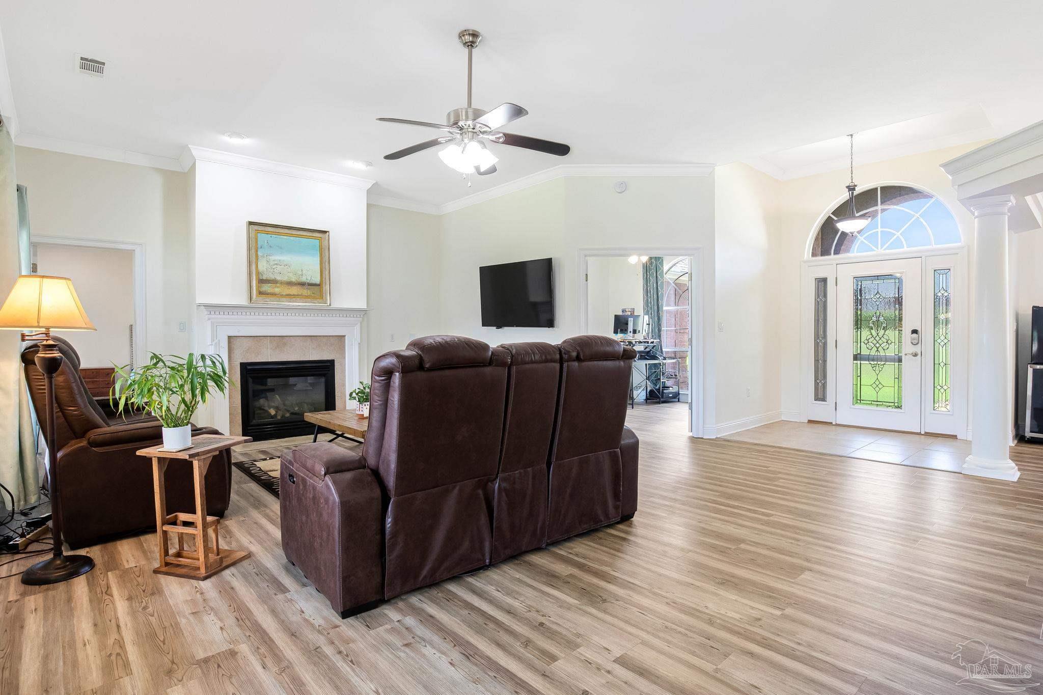 2822 Frederick Street Cantonment, FL 32533 - Photo 16 of 57 a living room with furniture and a fireplace