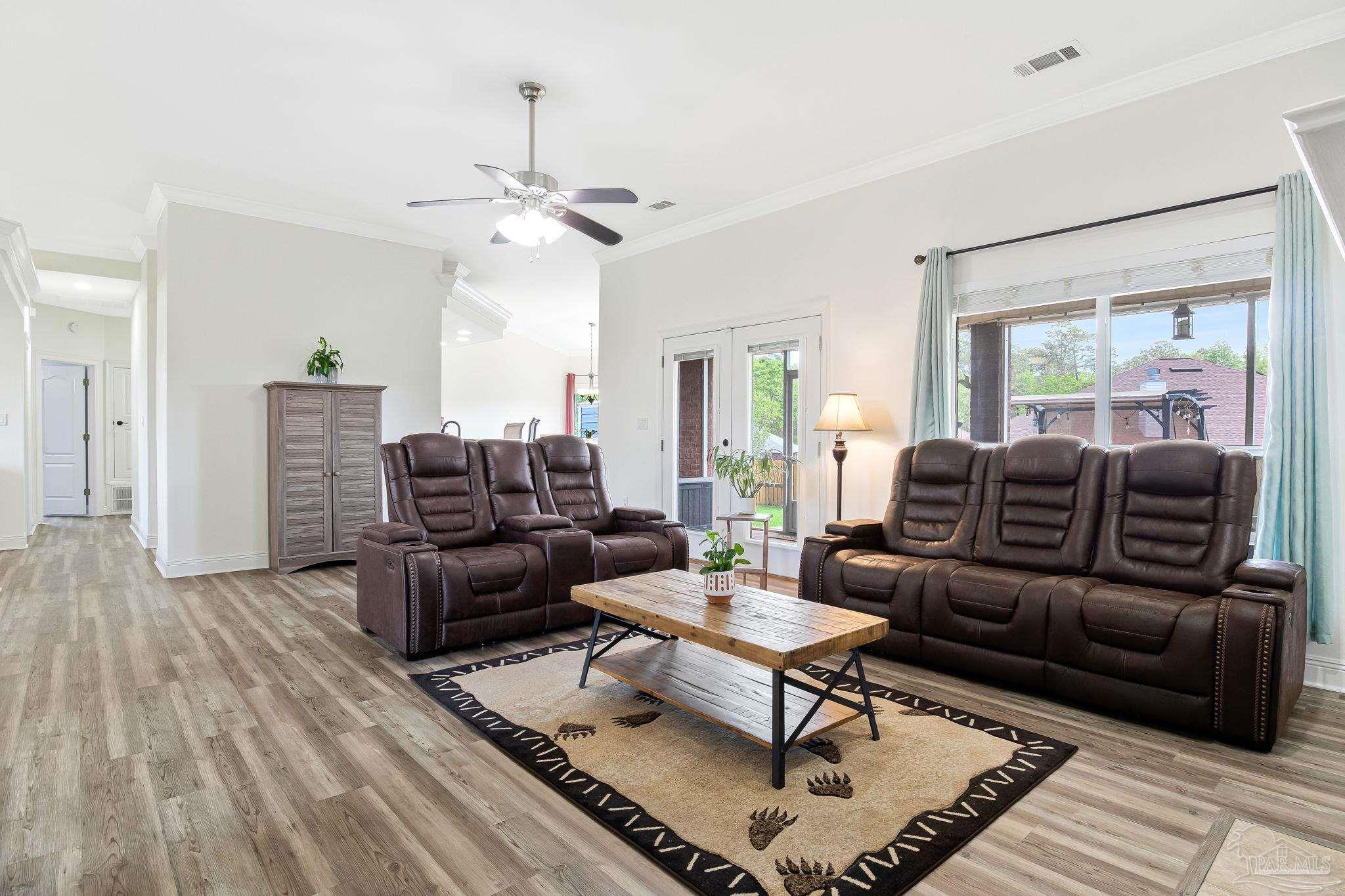 2822 Frederick Street Cantonment, FL 32533 - Photo 19 of 57 a living room with furniture a ceiling fan and a rug