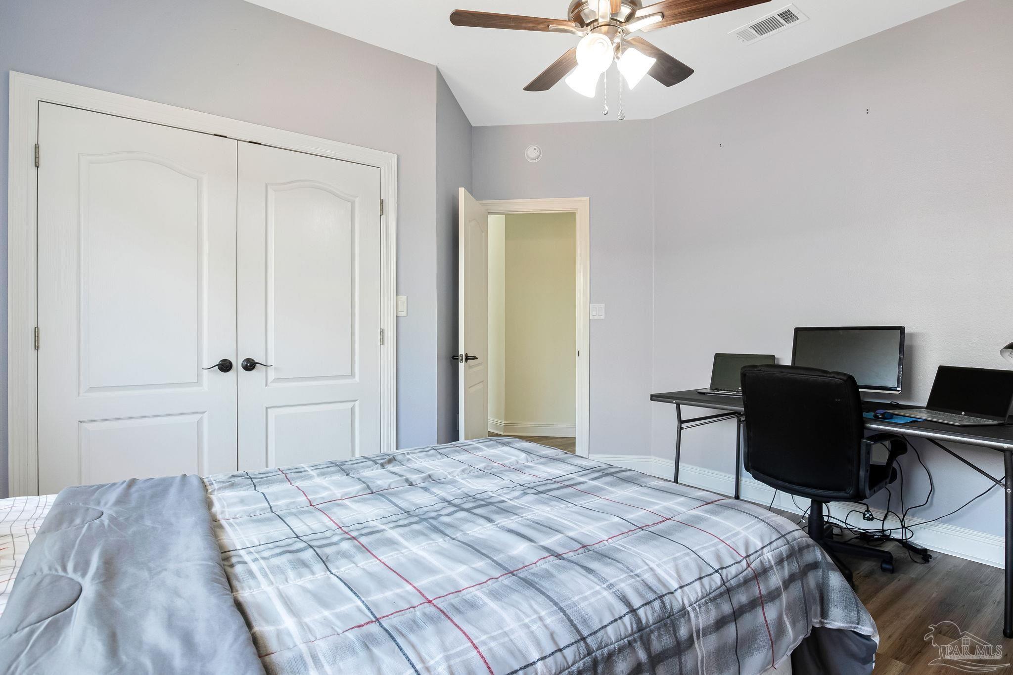 2822 Frederick Street Cantonment, FL 32533 - Photo 22 of 57 a bedroom with a bed and a desk