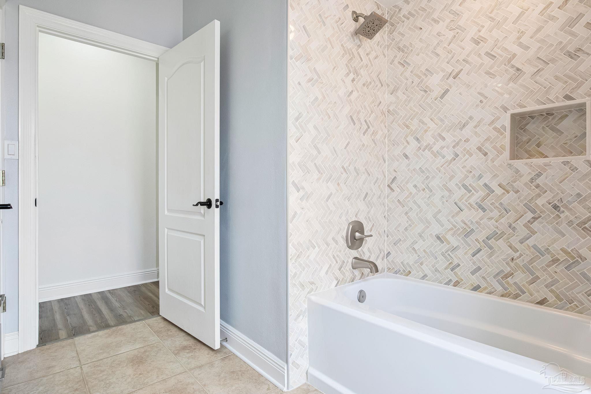 2822 Frederick Street Cantonment, FL 32533 - Photo 25 of 57 a bathroom with a bathtub