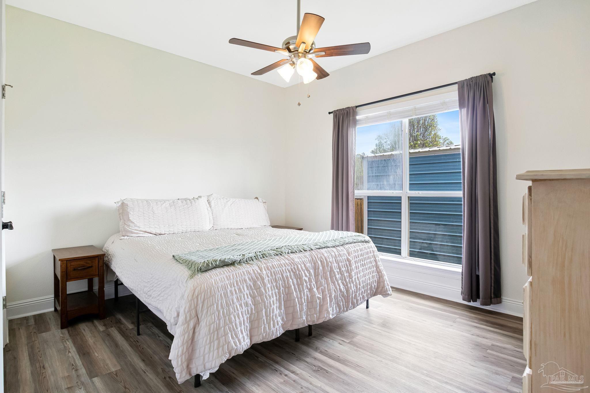 2822 Frederick Street Cantonment, FL 32533 - Photo 26 of 57 a bedroom with a bed and a large window