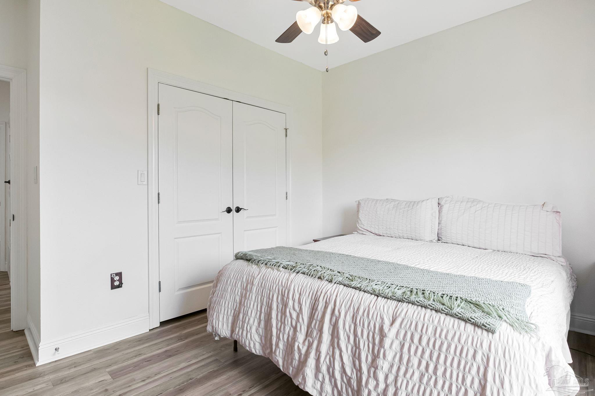 2822 Frederick Street Cantonment, FL 32533 - Photo 27 of 57 a bedroom with a bed and a chandelier