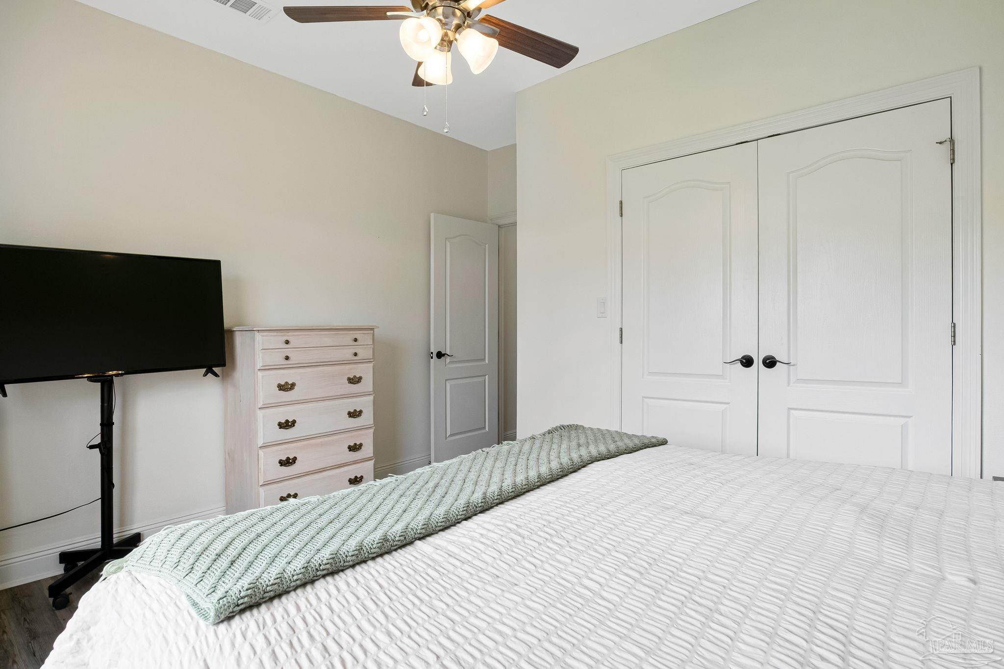 2822 Frederick Street Cantonment, FL 32533 - Photo 28 of 57 a bedroom with a bed and a flat screen tv