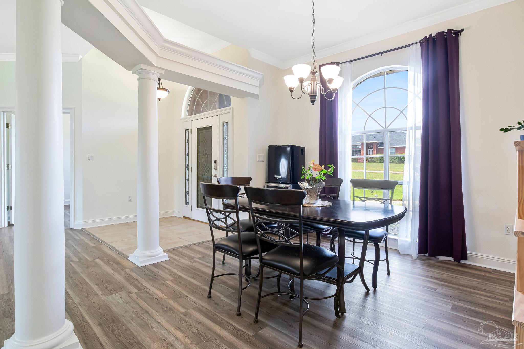 2822 Frederick Street Cantonment, FL 32533 - Photo 3 of 57 a view of a dining room with furniture window and wooden floor
