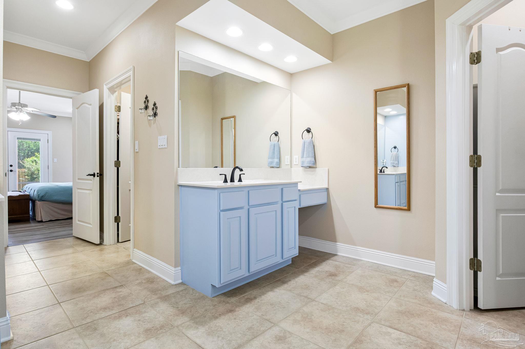 2822 Frederick Street Cantonment, FL 32533 - Photo 33 of 57 a spacious bathroom with a mirror sink and shower
