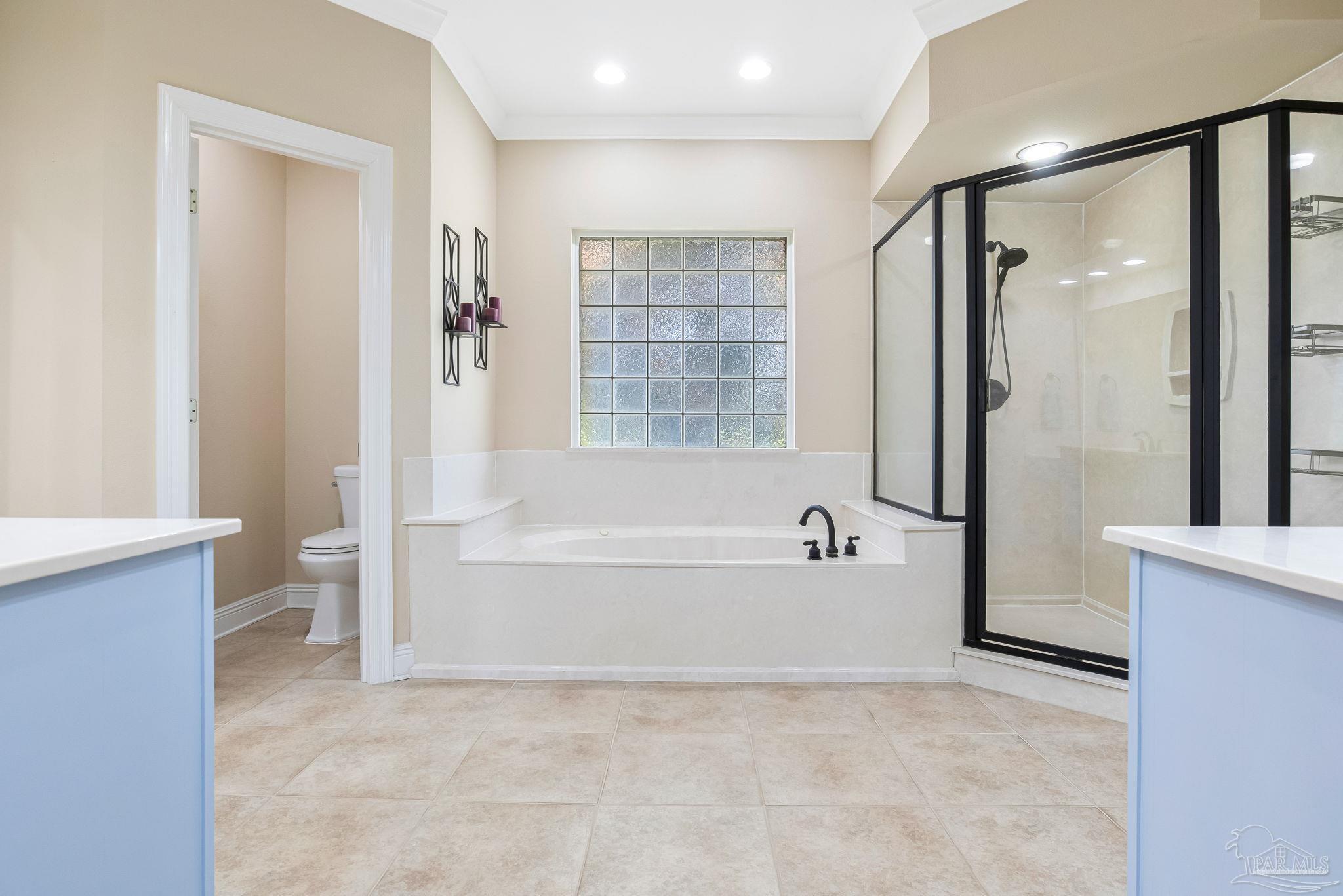 2822 Frederick Street Cantonment, FL 32533 - Photo 35 of 57 a bathroom with a bathtub and a shower