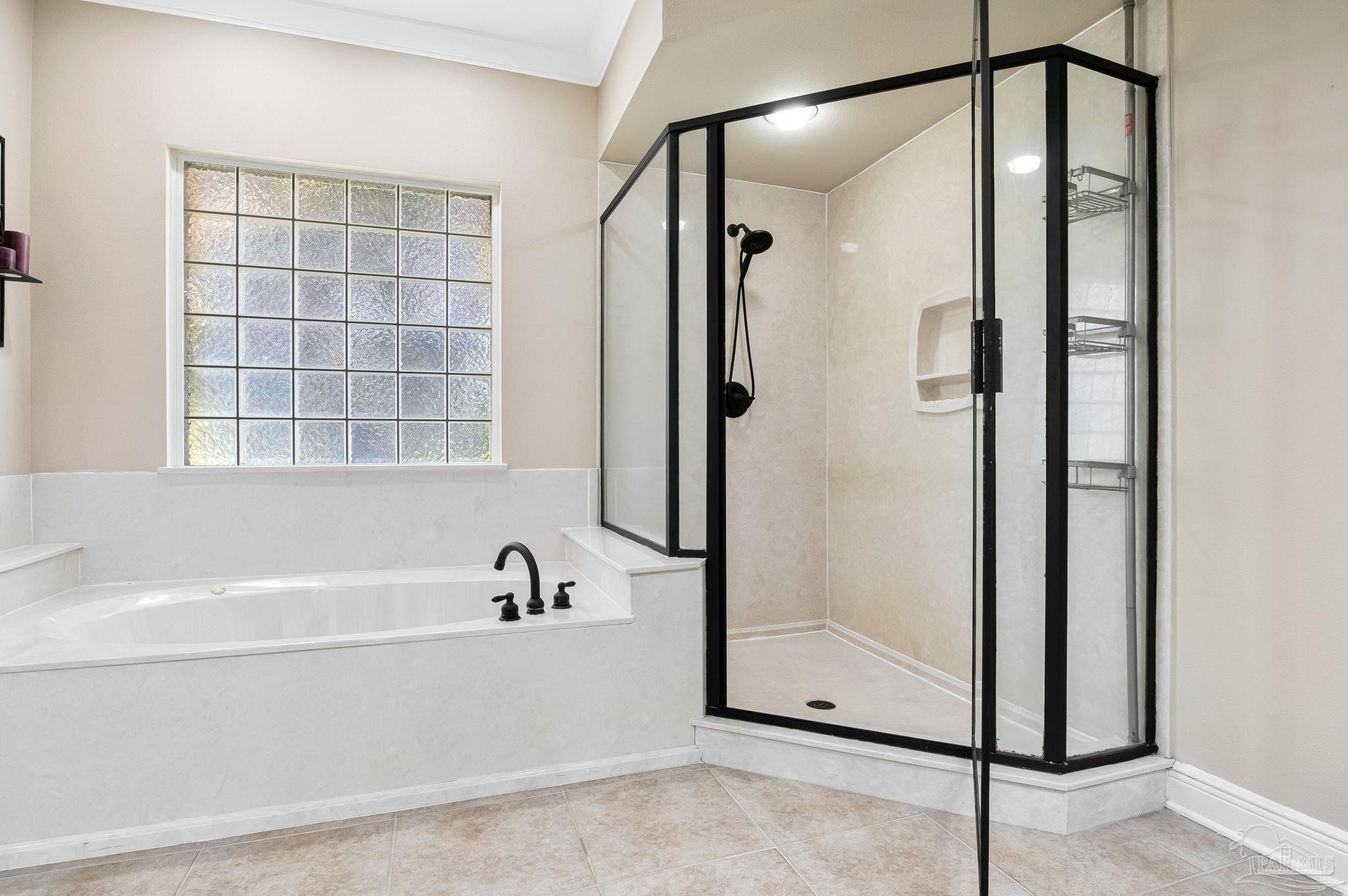 2822 Frederick Street Cantonment, FL 32533 - Photo 36 of 57 a bathroom with a bathtub and a shower