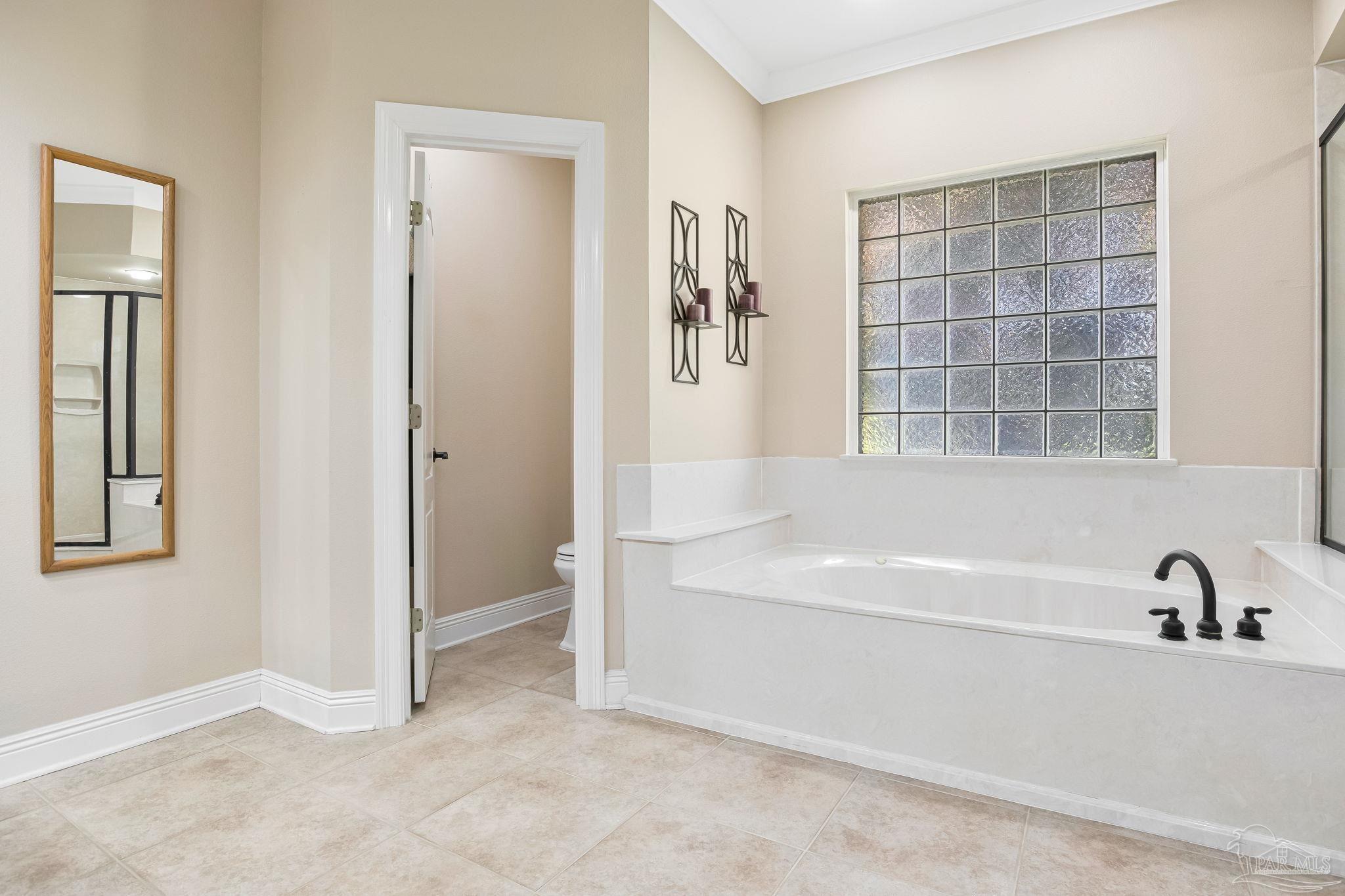2822 Frederick Street Cantonment, FL 32533 - Photo 37 of 57 a bathroom with a bathtub and a shower