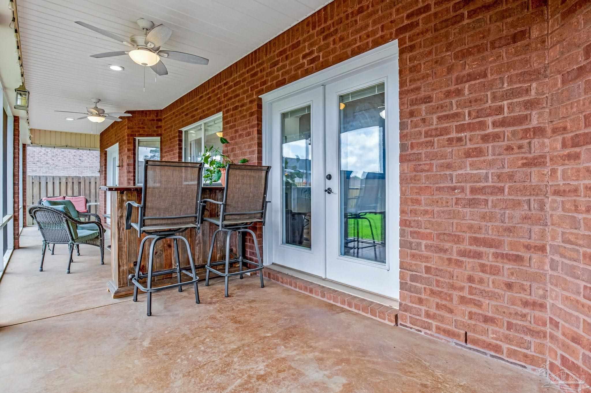 2822 Frederick Street Cantonment, FL 32533 - Photo 38 of 57 a view of dinning room with chairs and chandelier fan