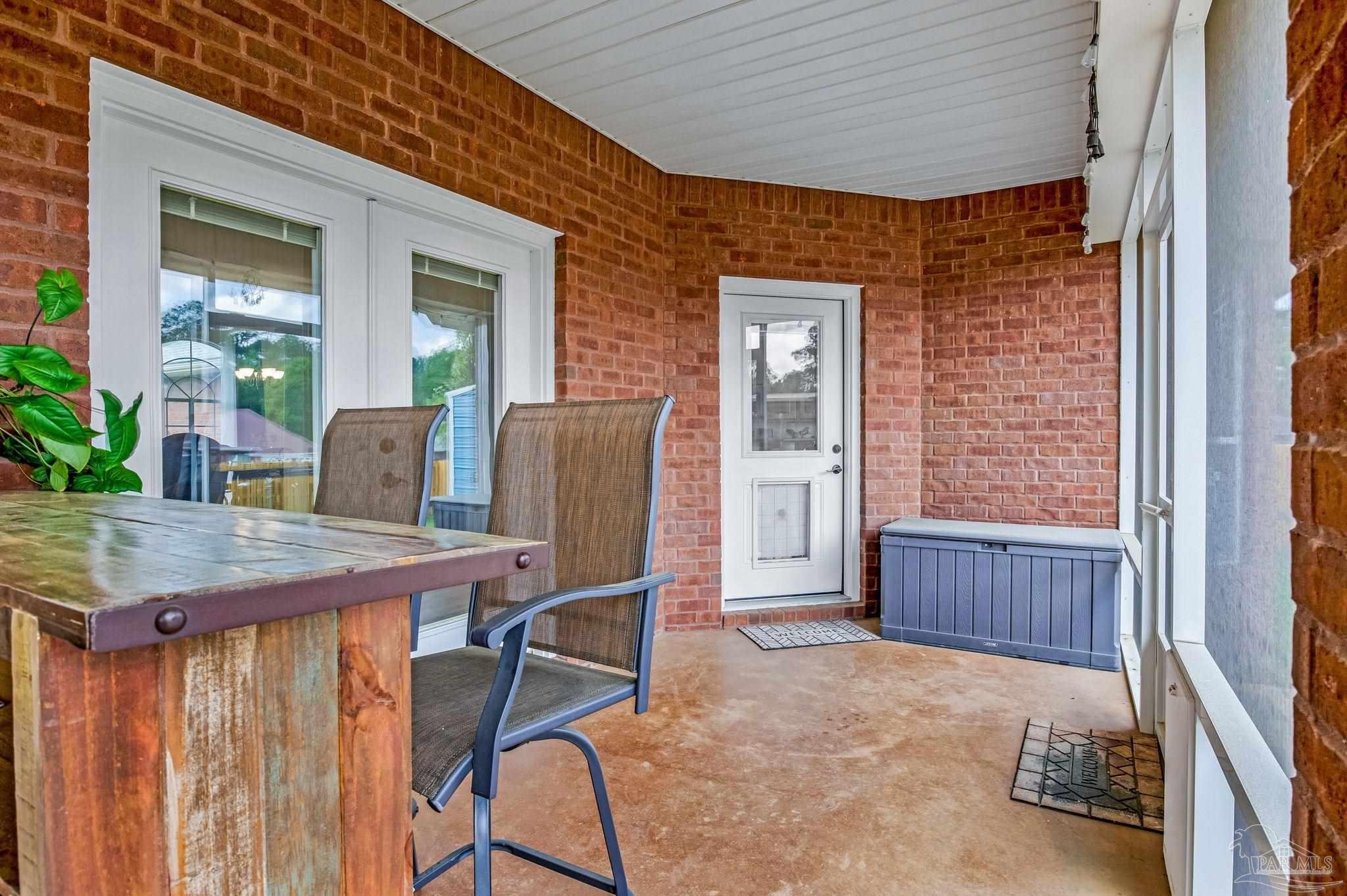 2822 Frederick Street Cantonment, FL 32533 - Photo 40 of 57 a patio with table and chairs and potted plants