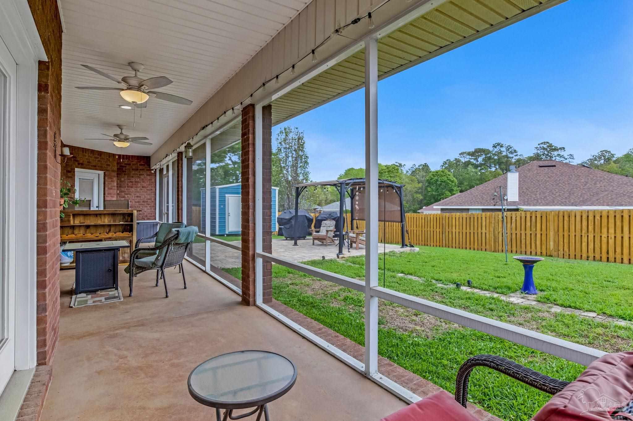 2822 Frederick Street Cantonment, FL 32533 - Photo 44 of 57 a view of a porch with chairs and backyard