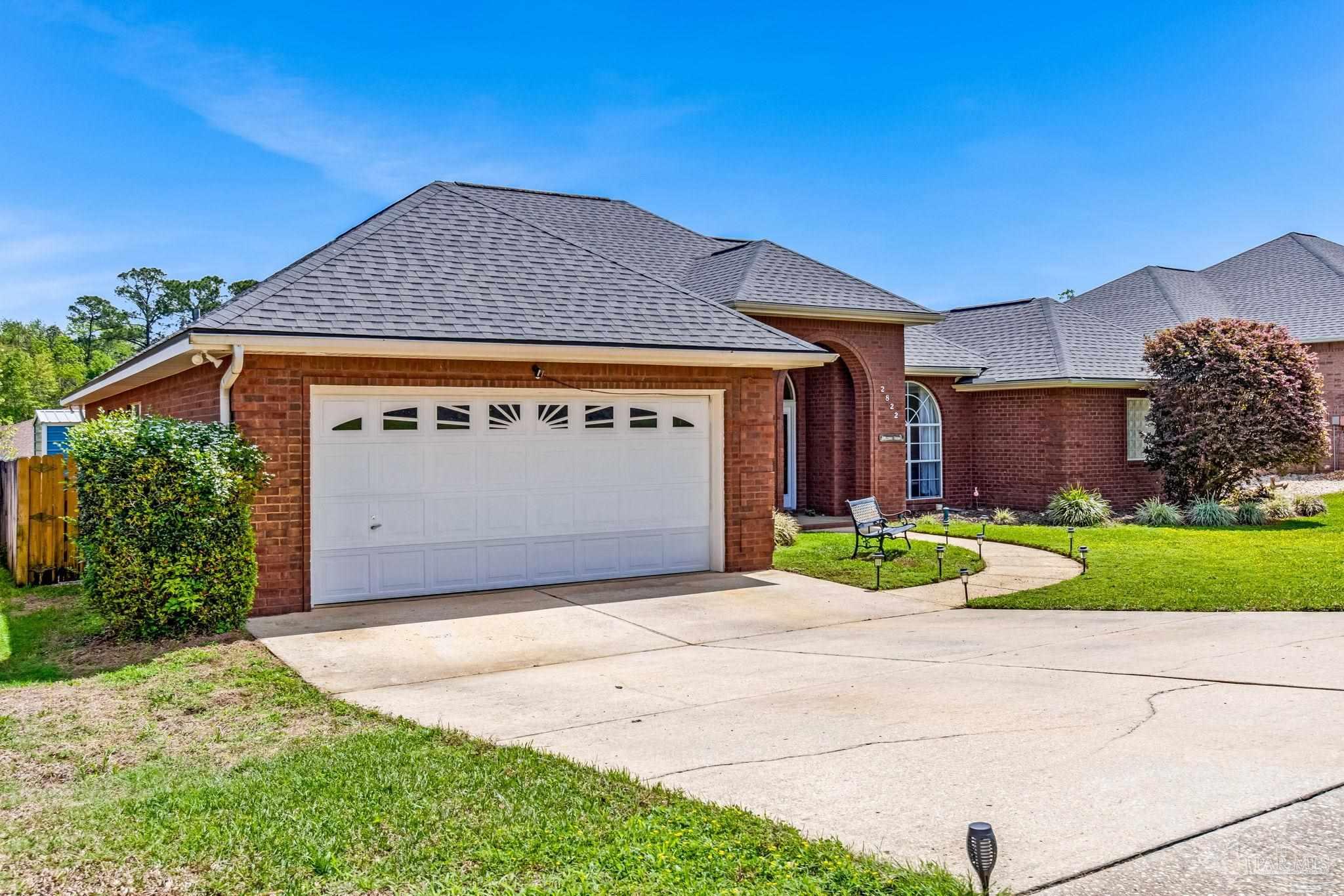 2822 Frederick Street Cantonment, FL 32533 - Photo 57 of 57 a front view of a house with a yard and garage