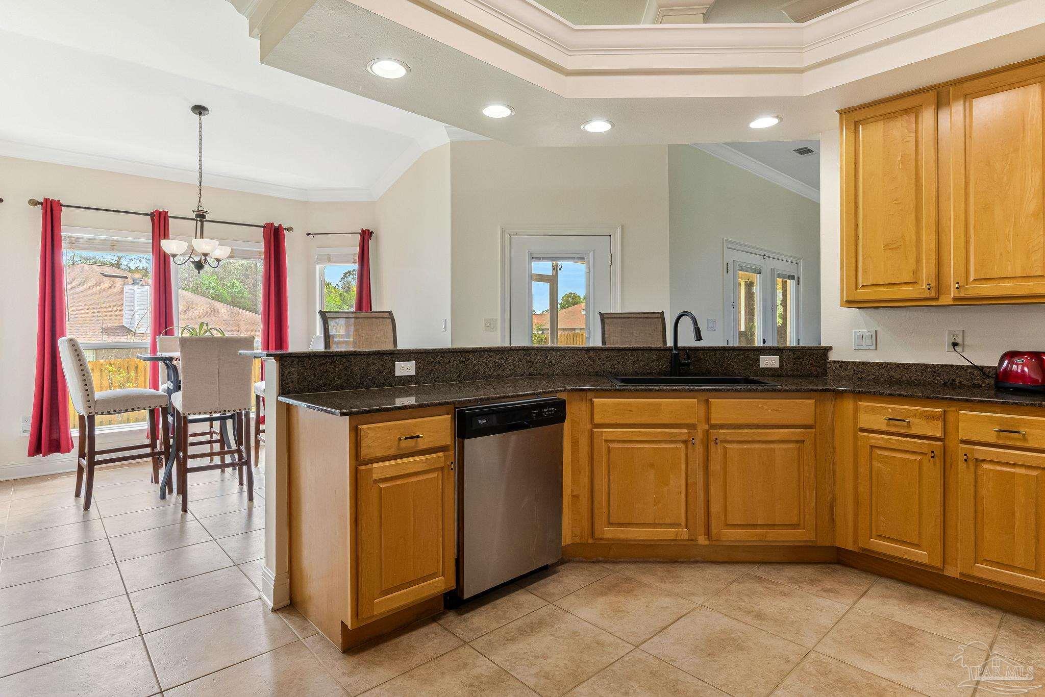 2822 Frederick Street Cantonment, FL 32533 - Photo 6 of 57 a kitchen with stainless steel appliances granite countertop a sink and cabinets