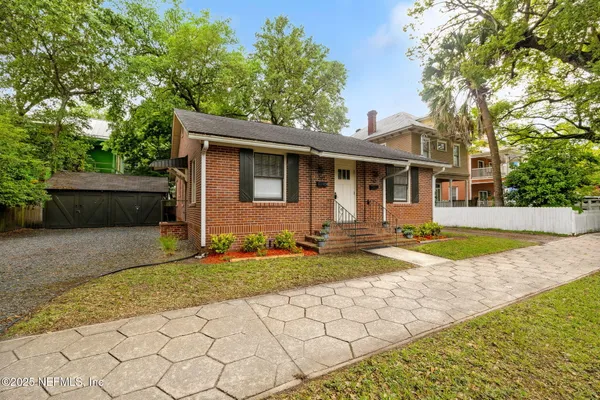 a view of a house with swimming pool and a yard