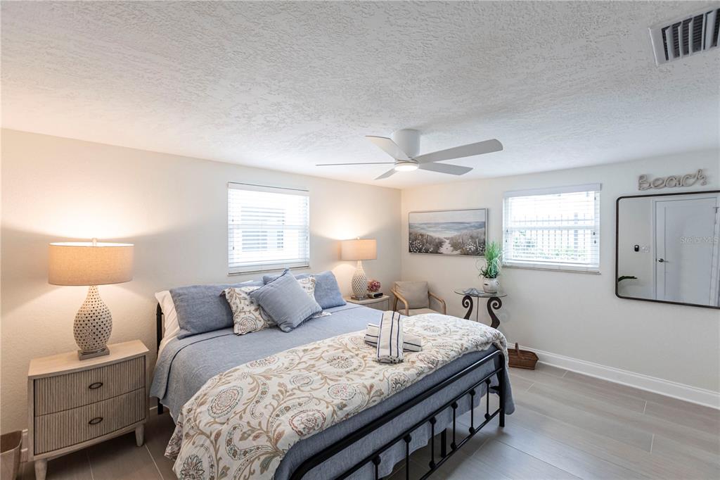 6154 Midnight Pass Road, Unit D15 Sarasota, FL 34242 - Photo 13 of 23 a bedroom with a bed and wooden floor