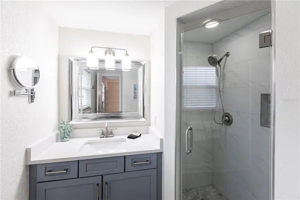 a bathroom with a sink vanity granite and a mirror