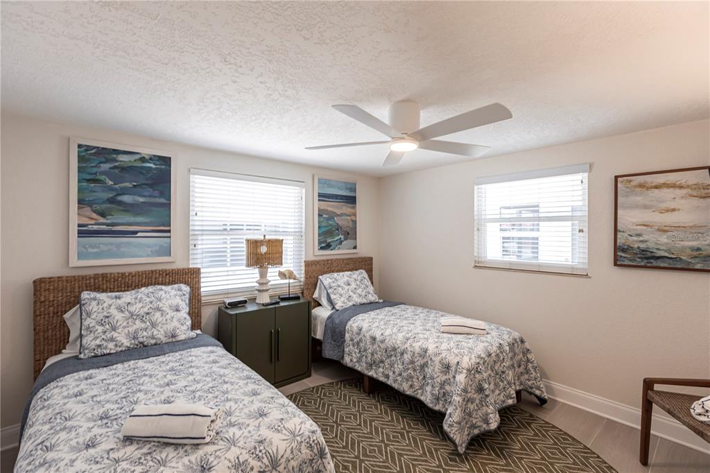 6154 Midnight Pass Road, Unit D15 Sarasota, FL 34242 - Photo 17 of 23 a bedroom with a bed and wooden floor