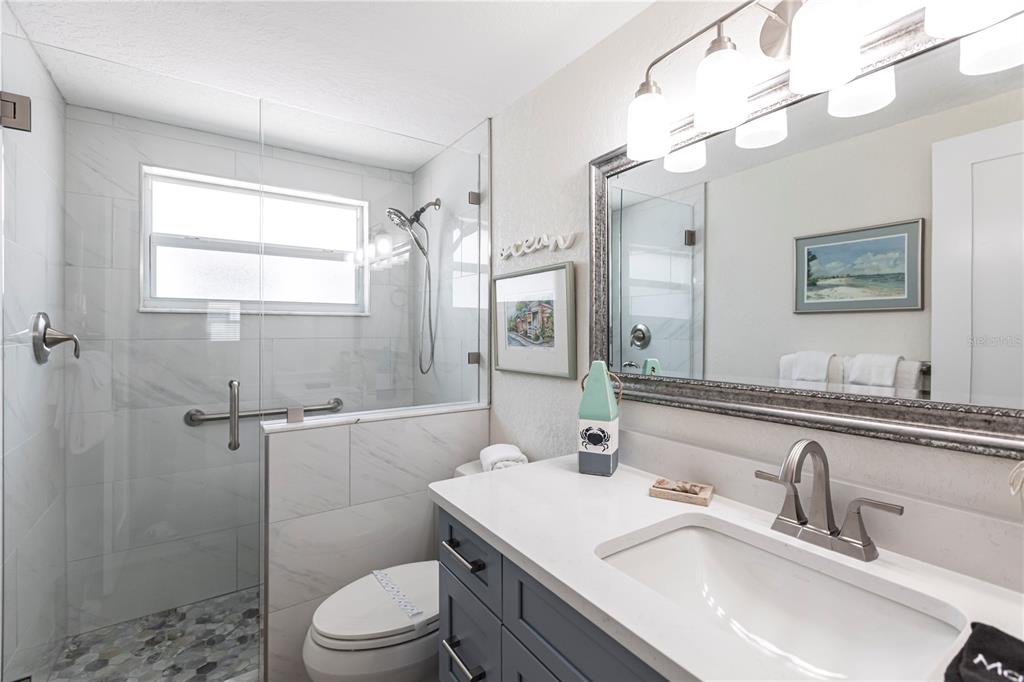 6154 Midnight Pass Road, Unit D15 Sarasota, FL 34242 - Photo 20 of 23 a bathroom with a sink toilet vanity and shower
