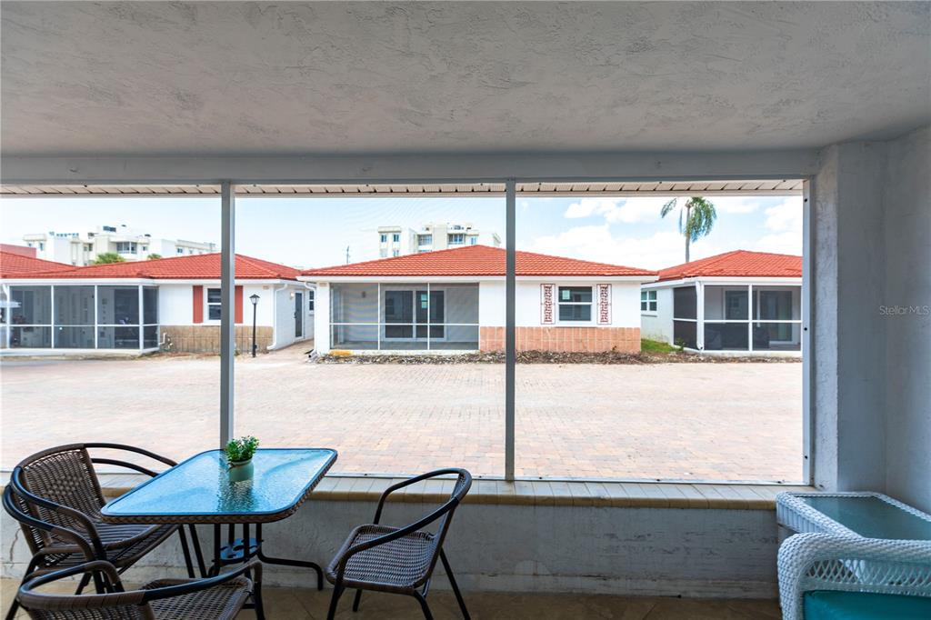 6154 Midnight Pass Road, Unit D15 Sarasota, FL 34242 - Photo 2 of 23 a balcony with table and chairs