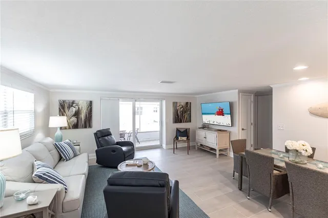 a living room with furniture a window and a flat screen tv
