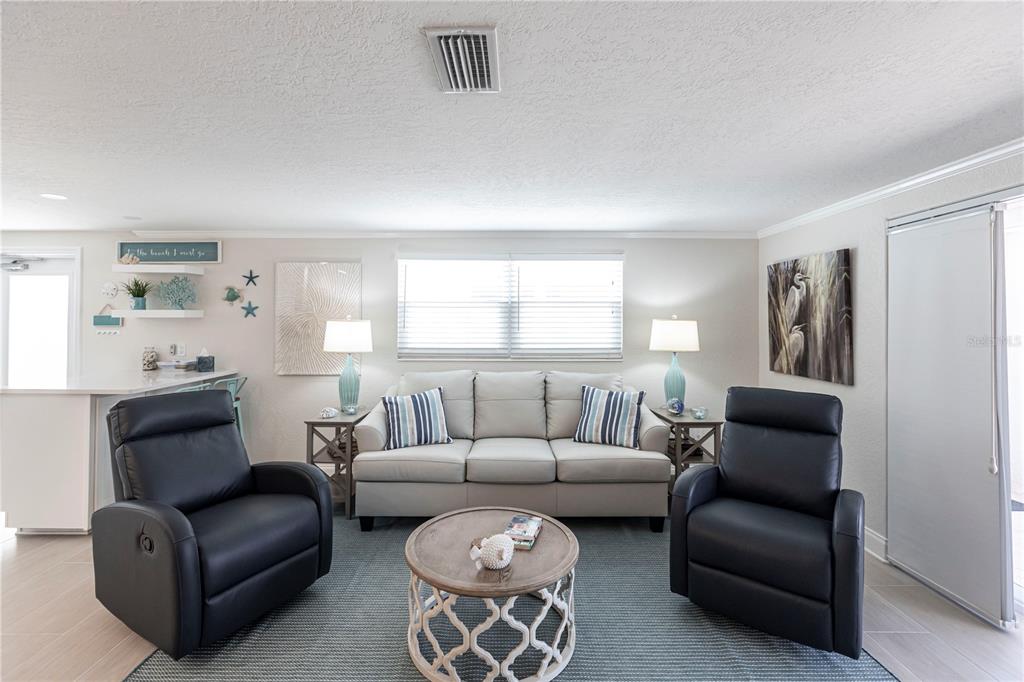 6154 Midnight Pass Road, Unit D15 Sarasota, FL 34242 - Photo 6 of 23 a living room with furniture and a large window