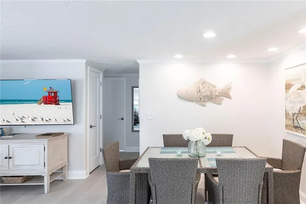 a view of a dining room with furniture and a chandelier
