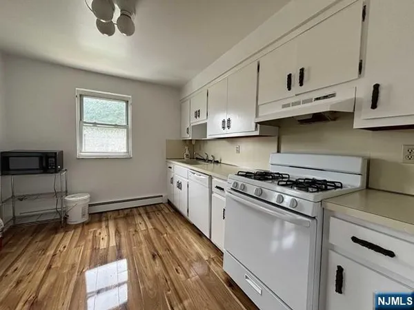 a kitchen with granite countertop a stove and a sink