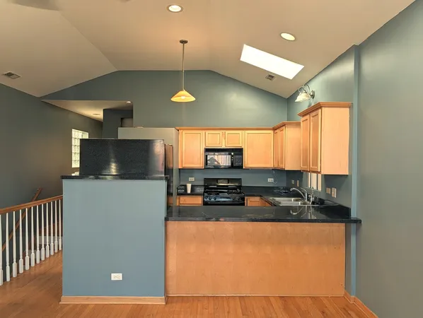 a kitchen with stainless steel appliances a stove a refrigerator and a sink