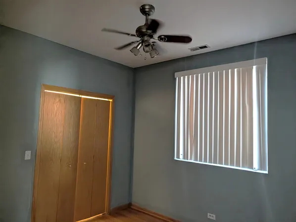 a view of a livingroom with a ceiling fan and window