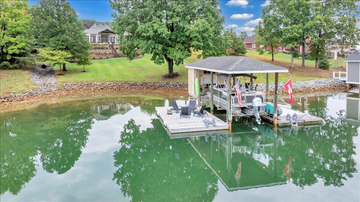 6 Compass Moneta, VA 24121 - Photo 3 of 60 a view of a lake with a table and chairs under an umbrella