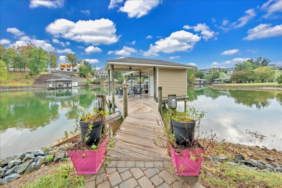 6 Compass Moneta, VA 24121 - Photo 43 of 60 a front view of a house with a lake view and a potted plant