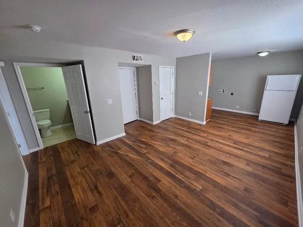 a bedroom with a bed and a mirror