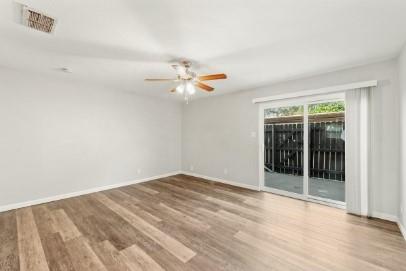 7700 Chapin Road, Unit 7 Fort Worth, TX 76116 - Photo 4 of 13 Spacious interior room featuring wood-finish flooring, a ceiling fan with integrated lighting, and light-toned walls