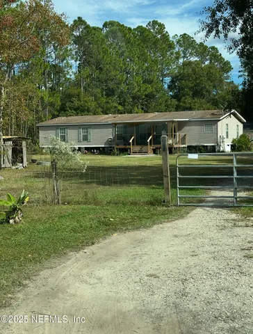 a view of a house with a backyard