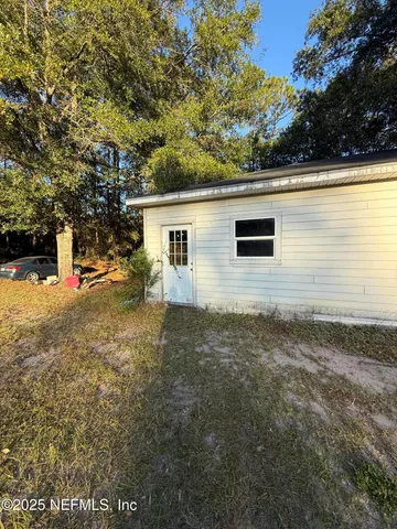a backyard of a house with table and chairs