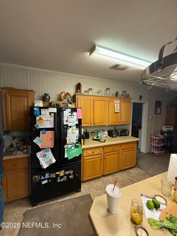 a kitchen with stainless steel appliances kitchen island granite countertop a refrigerator stove and a sink